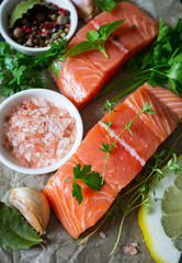 fresh salmon fillet on black stone surface