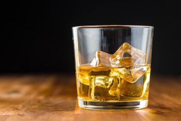 Glass of alcoholic drink with ice cubes.