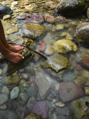 Closeup Men's  feet soaked in stream water