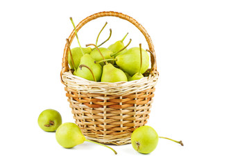 Fresh green pears in wicker baskets isolated on white background