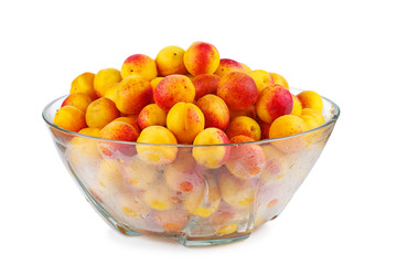 Fresh apricots in glass bowl isolated on white background