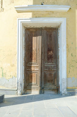 Fototapeta premium An ancient wooden door to the building. The door to a new life.