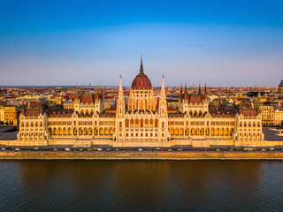 Fototapeta na wymiar Budapest, Hungary - Aerial view of the beautiful Parliament of Hungary (Orszaghaz) at golden sunset with clear blue sky
