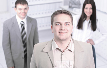 confident young businessman on background of office