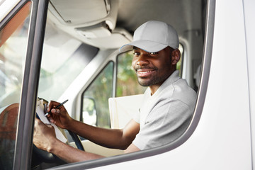 Courier Delivery. Black Man Driver Driving Delivery Car 