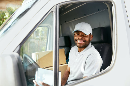Courier Delivery. Black Man Driver Driving Delivery Car 
