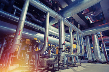Equipment, cables and piping as found inside of a modern industrial power plant. Industrial zone,...