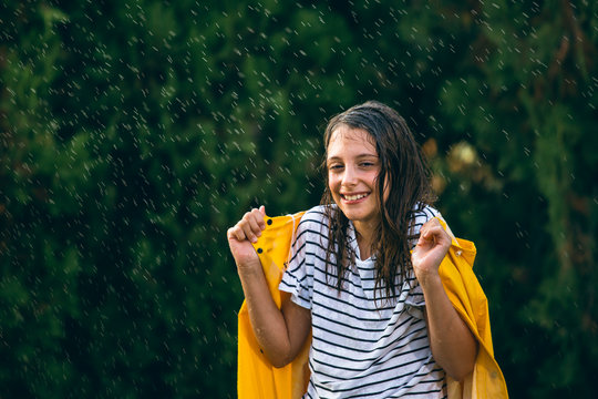 Girl With Yellow Raincoat In Rain