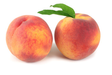 Fototapeta na wymiar peach fruit with green leaf isolated on white background