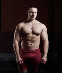 Fototapeta premium portrait of handsome male bodybuilder isolated on black background