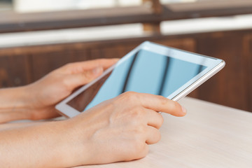 woman holding digital tablet, closeup