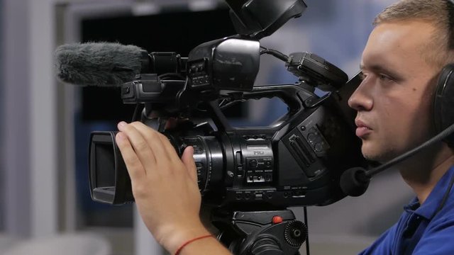 Camera operator working with a cinema broadcast TV camera