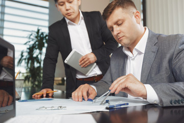 Confident team of engineers working together in a architect studio.