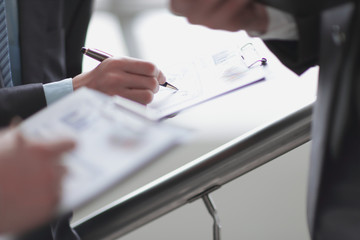 Close up of business people hands pointing growing financial bu