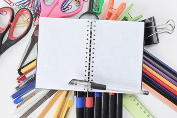 opened Notepad on office supplies on white background