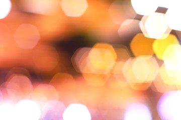 Blurred background with flare lights and light bokeh bubbles, orange and gold color