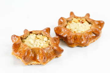 Tasty pastry of rye dough cut in half. Delicious pastries with potatoes on light background.