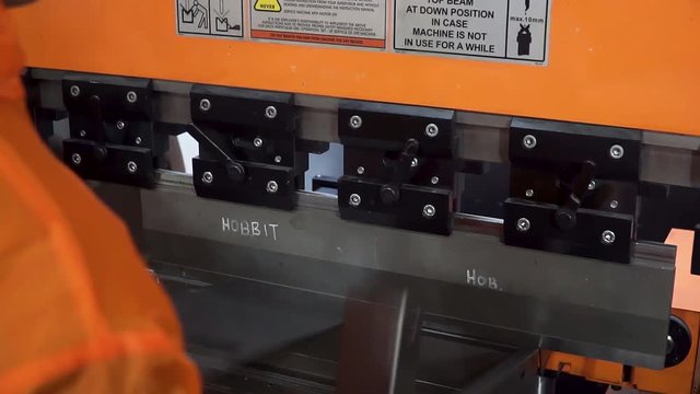 Operator bending metal sheet by sheet bending machine, high precision and high accuracy metal sheet bending machine. Clip. The technician operator use hydraulic bending machine. Metal working concept