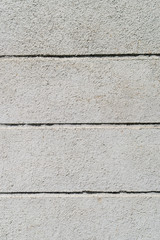 Texture of a rough gray concrete wall with horizontal stripes. Backdrop for design. Abstract background. Vertical.