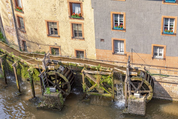 waterfall in the city center of Saarburg, Germany surrounded by houses on a hill