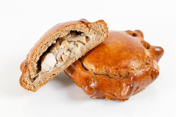 Tasty pastry of rye dough cut in half . Delicious pastries with minced meat on light background.