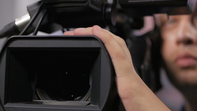 Camera operator working with a cinema broadcast TV camera