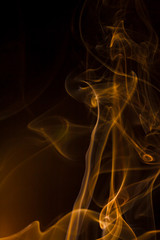 Gold smoke on black background.