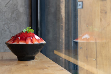 Korean shaved ice dessert with sweet toppings, Strawberry Bingsoo or Bingsu with soft focus, using as a background or wallpaper