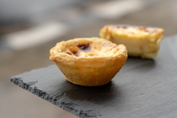 Delicious Asian Egg tart from the Hong Kong famous shop on the wood table for healthy coffee break in the afternoon tea