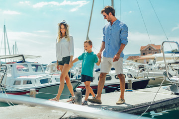 Happy family having fun, enjoying the summer time by the sea.