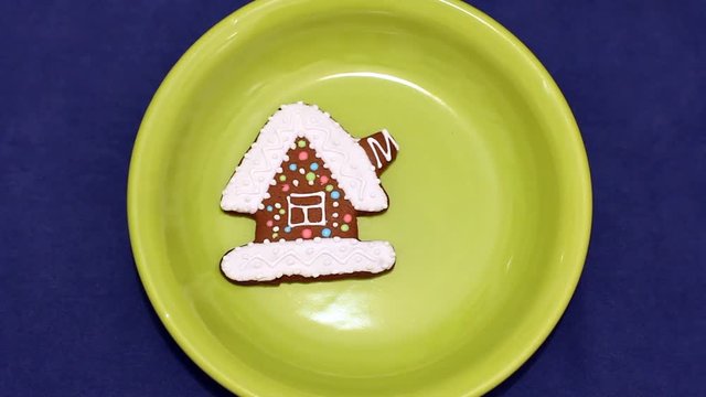 hand puts on the plate composition of gingerbread of different shapes, traditional Russia North (Arkhangelsk) christmas bakery 
