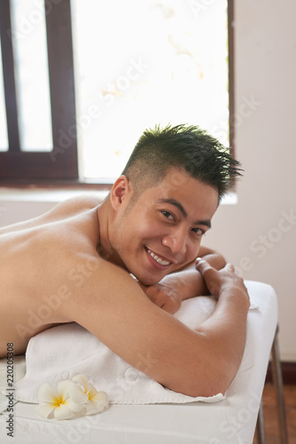 Portrait Of Handsome Young Asian Man Attending Massage Salon Portrait Of Handsome Young Asian Man Attending Massage Salon