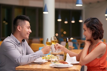 Young Vietnamese couple celebrating anniversary in restaurant