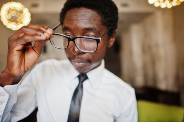 Close up of business african american man wear on white shirt, tie and glasses at office.