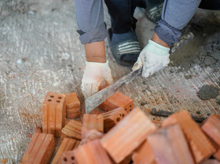 Close up of industrial bricklayer installing bricks on construction site in thailand