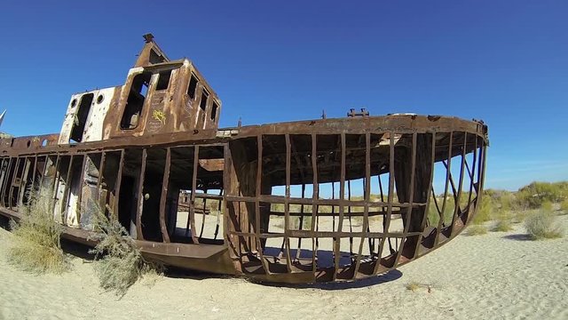 Dead rustic ship on a ship graveyards on a desert around Moynaq (Muynak or Moynoq) - Aral sea, Uzbekistan, Central Asia.