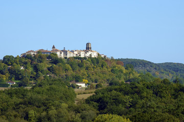 Fototapeta na wymiar A long distance view across rural Lot et Garonne countryside to the picturesque hilltop town of Tournon d'Agenais, France