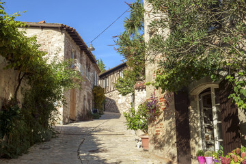 Fototapeta na wymiar Traditional architecture in the narrow streets of travel destination Penne d'Agenais, Lot et Garonne, France. This idyllic hilltop village has extensive views.