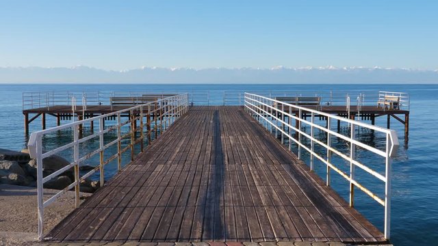 Beautiful background with empty pier on Issyk-Kul lake