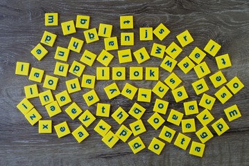 Word Look among the blocks of English letters scattered. English alphabet letters spread. Concept of focus or concentration.