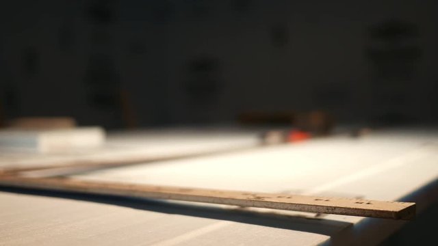 Close up of T-Square over Blue Board in unfinished basement