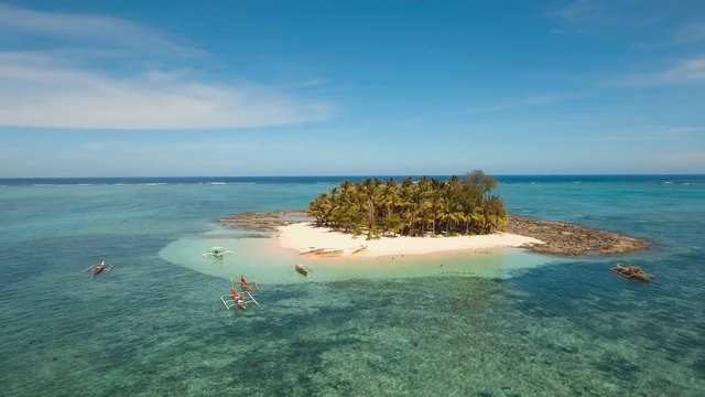 aerial footage tropical island with beach and palm trees lagoon with turquoise water Sea tropical landscape Guyam island, Philippines, Siargao. Travel concept Aerial video
