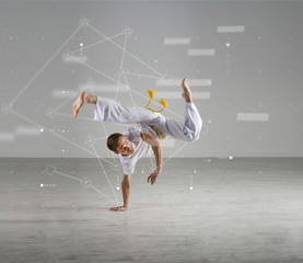 Man practicing Capoeira , brazilian martial Art. Sport science, biomechanics, information technology concept