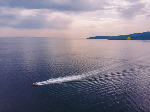 speed boat pull parasailer in sea.