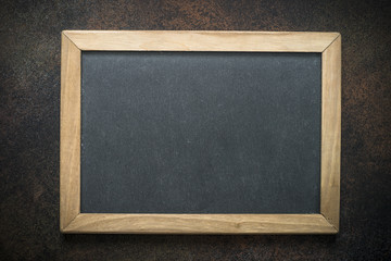Vintage chalkboard in wooden frame on darke background. 