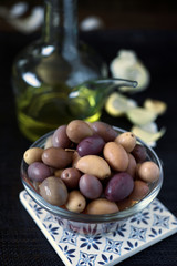 olive olive oil and condiments on dark burlap background