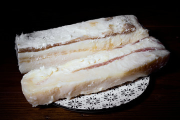 pieces of Iberian bacon on wooden board