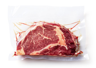 Beef steak vacuum sealed isolated on white, from above © bigacis