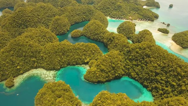 aerial footage islands in lagoon with turquoise water Bucas Grande Island Sohoton Cove. tropical seascape blue sea, azure lagoon. Flying over the azure surface ocean. Travel concept
