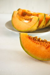 Freshly cut orange cantaloupe melon, with copy space